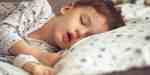 Child sleeping with their mouth open, a common sign of sleep-disordered breathing