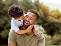 Dad and son smiling after biometric restoration procedure at Chester Dental Care in Chester, VA